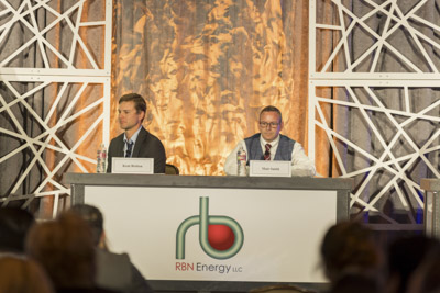 Corporate event photography, executive fireside chat interview on stage at business conference.