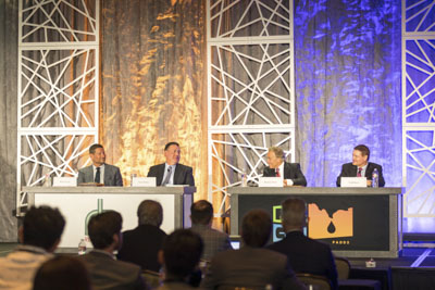 Corporate event photography, executive fireside chat interview on stage at business conference.