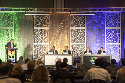 Corporate event photography, executive fireside chat interview on stage at business conference.