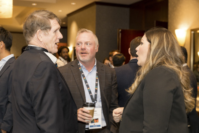 Corporate event networking, conference attendees connecting and talking during reception.